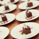 circa events dessert hazlenut parfait with raspberry drizzle on white plate