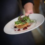 circa events portobello mushroom and brie tart held by a member of staff on white plate