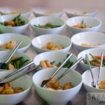 circa events sharing sides including roast potatoes and vegetables in white bowls with metal cutlery