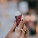 mini gelato cone canape held by guest covered in chocolate dried raspberries