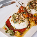 burrata starter with tomatoes, pine nuts and dressing