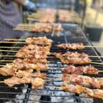 chicken on skewers cooked on asado bbq in courtyard