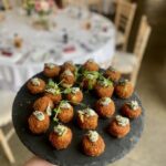 haddock fishcakes canape on black slate against wedding table